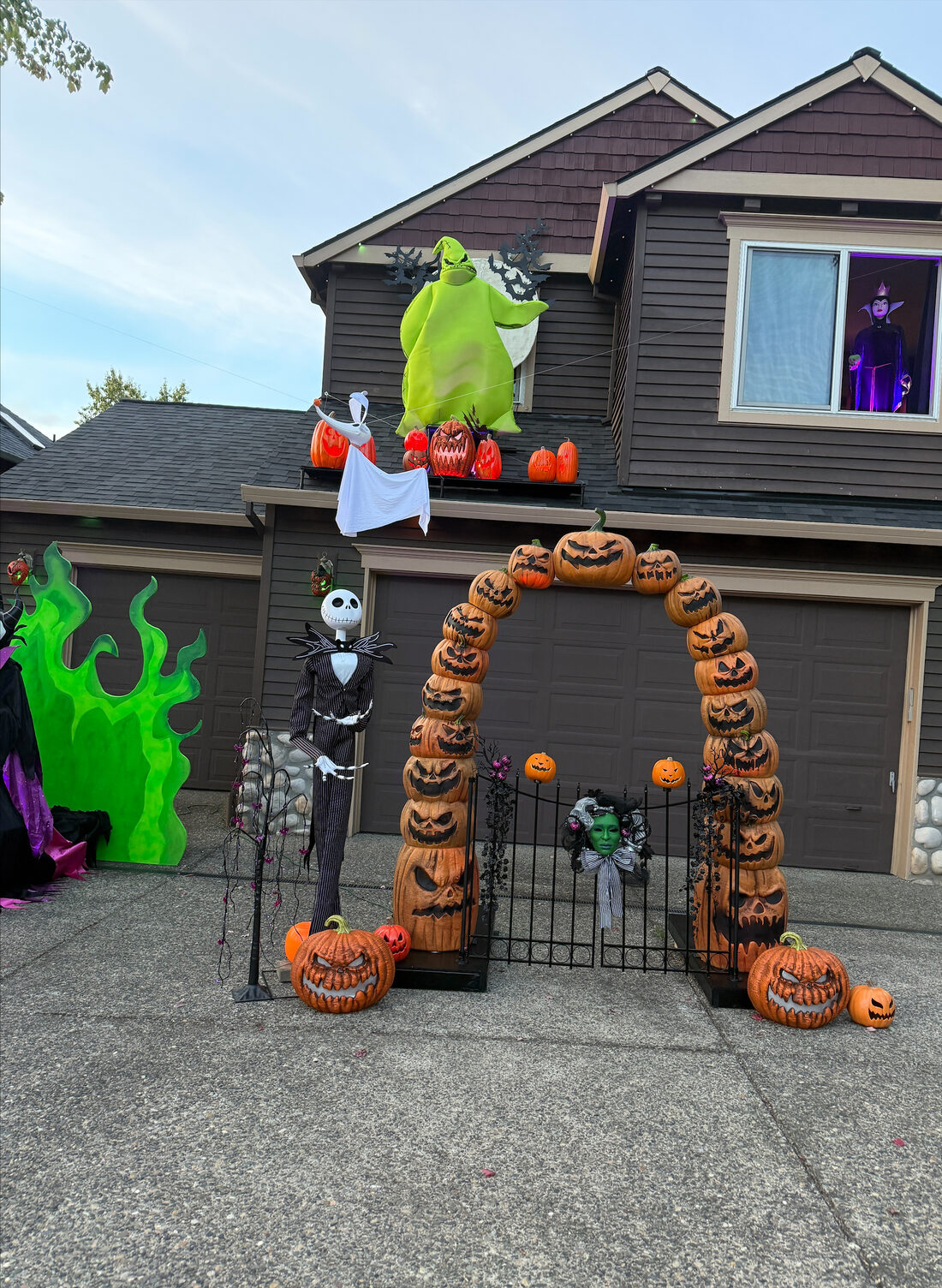 A pumpkin-stack arch with Jack Skellington, Oogie Boogie and the Evil Queen in an upstairs window