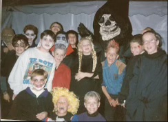 Andrew Ward as a 7th grader with neighborhood volunteers and the Grim Reaper at the haunted house he built